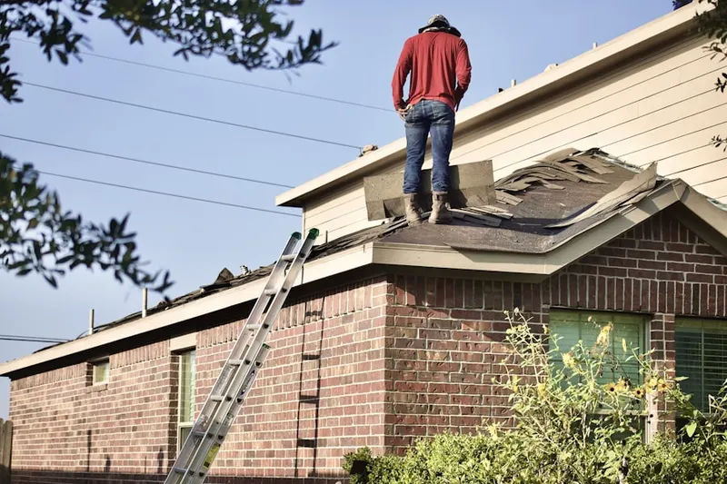 Professional roofer working on a residential roof in Catharpin Farms